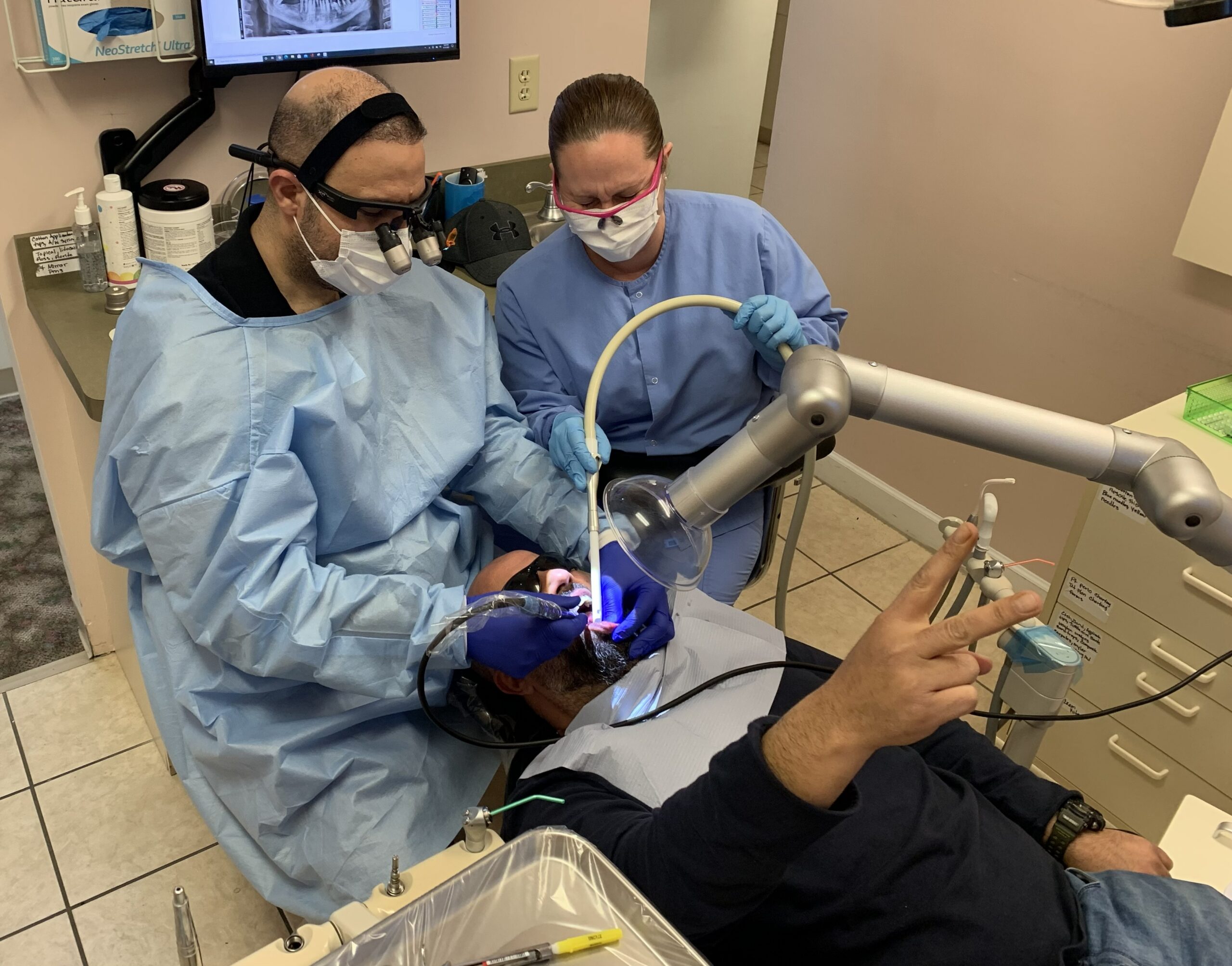 Dr. Firas Albadran performing safe mercury amalgam removal using extra-oral suction and full SMART protocol protective equipment at Richmond Dental Spa