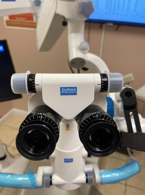 Zumax dental surgical microscope in the treatment room at Richmond Dental Spa — used by Dr. A for microscopic precision dentistry