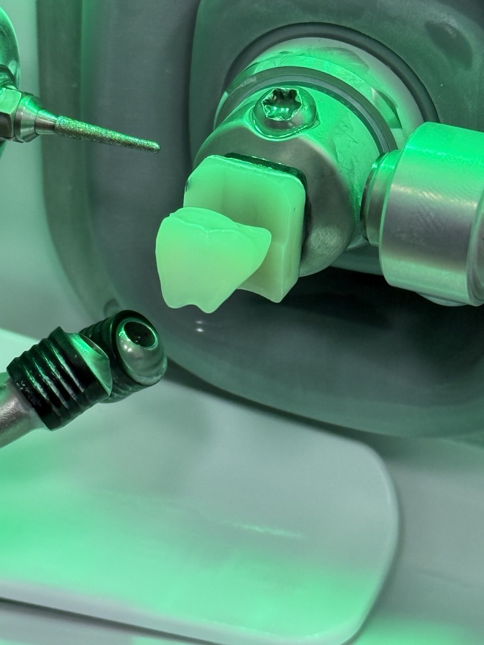 CAD/CAM milling machine actively cutting a ceramic block to fabricate a same-day crown at Richmond Dental Spa